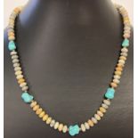 A 17" leopard skin jasper and turquoise beaded necklace with gold tone T bar clasp.