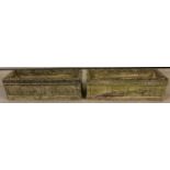 A pair of rectangular trough Cotswold Studios U27 stone planters with carved rose detail to sides.
