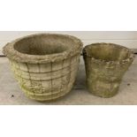 2 vintage round concrete garden planters. Largest has floral decoration.