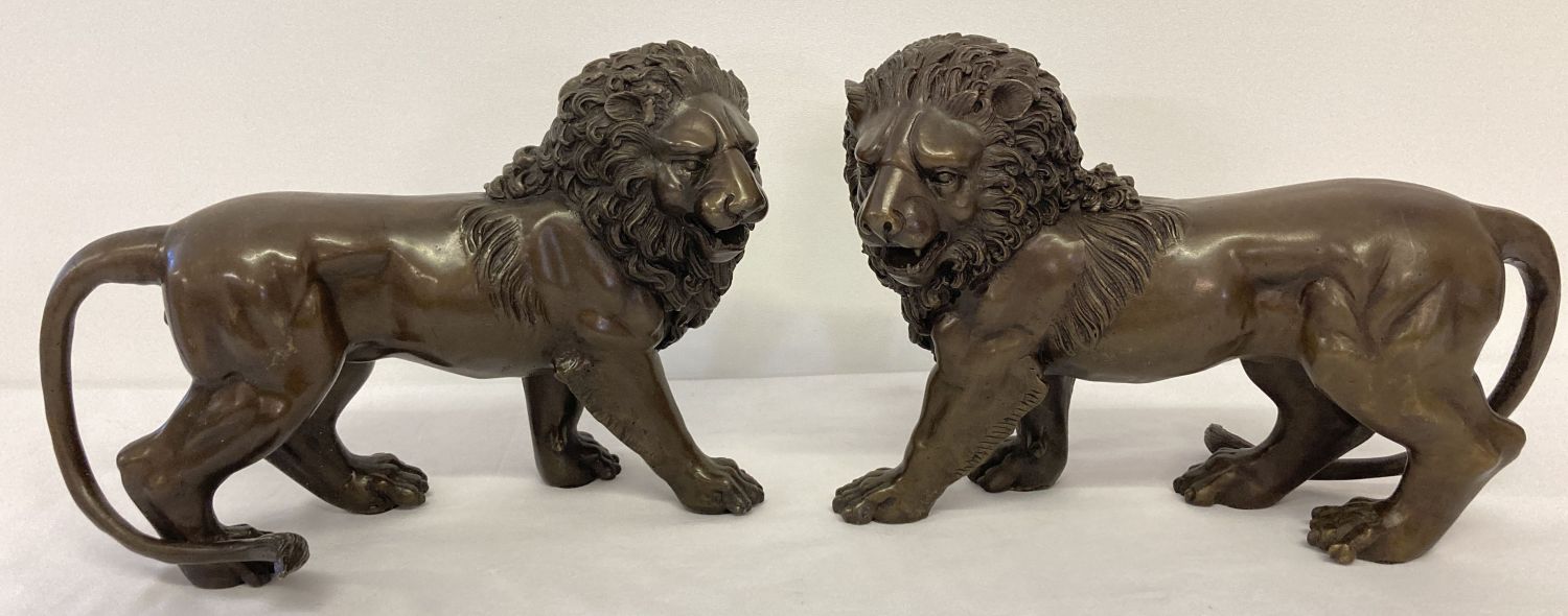 A pair of brass bronzed effect roaring lion mantel figures.