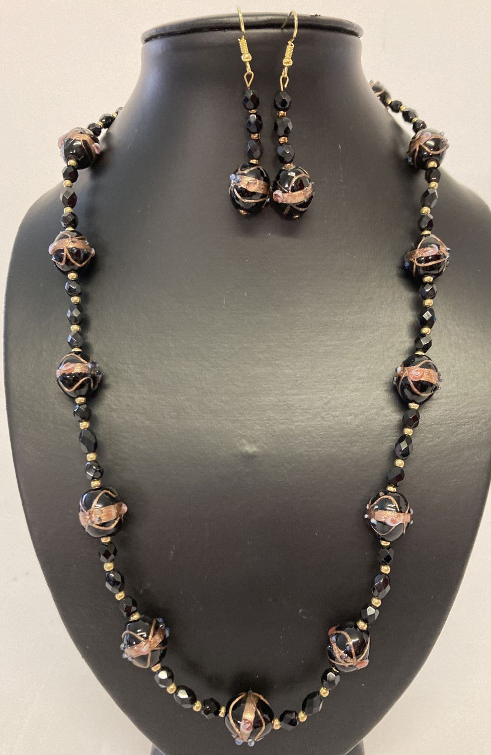 A matching necklace and earrings set made with black Venetian style glass beads.