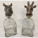 A pair of modern glass decanters with animal head shaped gilt effect stoppers.