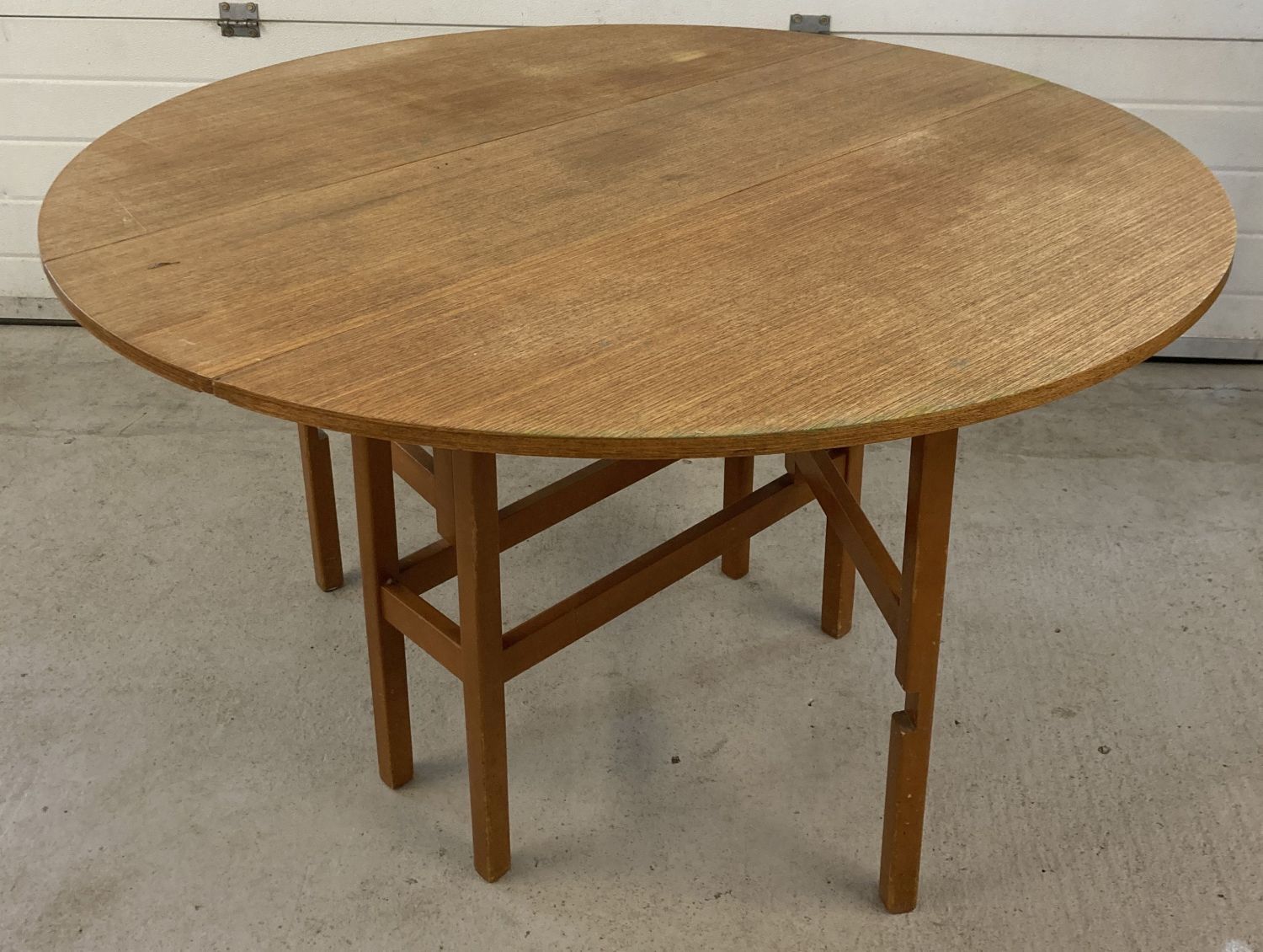 A vintage 1970's teak circular drop leaf, gate leg table.