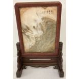 A wooden framed Chinese dreamstone screen with handpainted signature marks to one side.