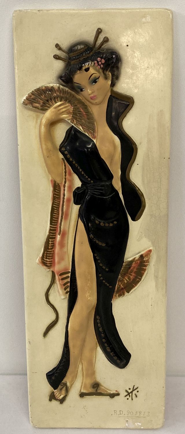 A 1960's chalk plaque depicting an oriental lady. Registered number to front.