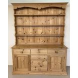 A large pine dresser with 6 drawers and 2 cupboards to base and 3 shelves to top.