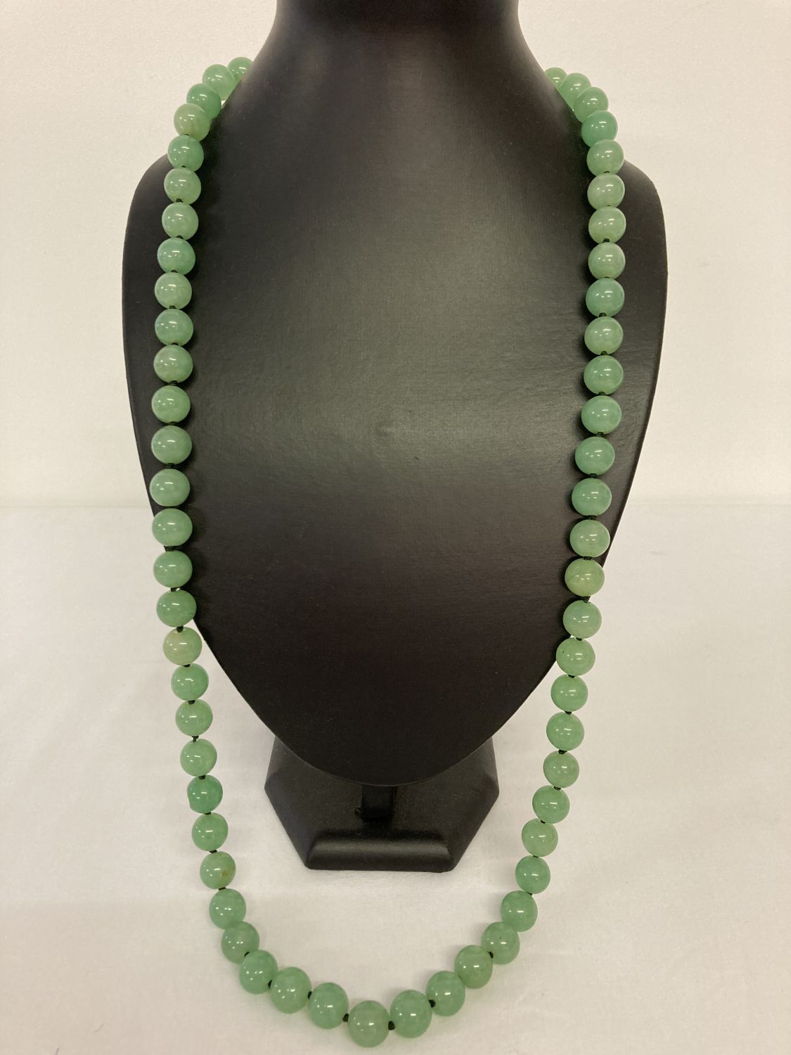 A 32" Chinese apple jade beaded necklace, knotted between each bead.