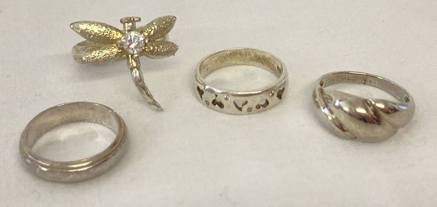 4 silver and white metal dress rings.