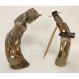 2 vintage carved horn figures, a horse and a man with sword, reading a book.