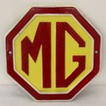 A painted cast iron octagonal shaped MG wall plaque.