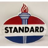 An oval shaped painted cast metal Standard Oil wall plaque, in red, blue & white.