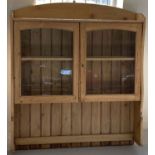 A pine glass fronted 2 door dresser top with interior and top shelf, slatted back and shaped sides.