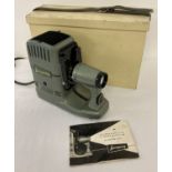 A vintage Liesegang Fanti slide projector with wooden carry box and instruction book.