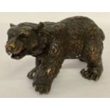 A small hollow bronze figurine of a bear.