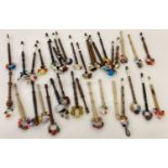 35 assorted beaded lacemaking bobbins with turned wooden handles.