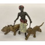 A small cold painted figure of an Arab boy with 2 lions.