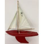 A vintage Red Star SY2 12 pond yacht with 12 inch wooden hull and metal keel.