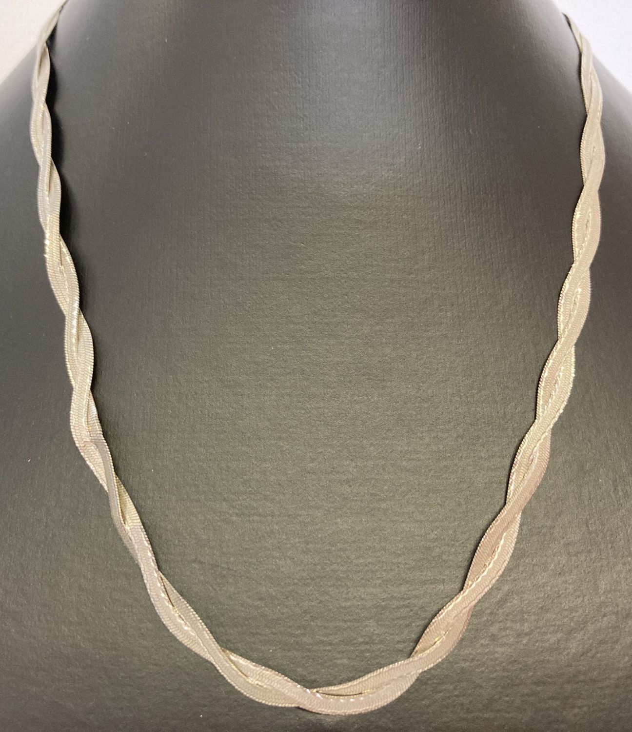 A plaited design 9ct white gold herringbone chain necklace with rose gold clasp.