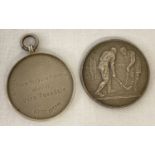 2 medals, an antique silver medal with laurel leaf detail to one side and inscription to the other.