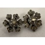 A vintage double flower design white gold brooch set with diamond chips.