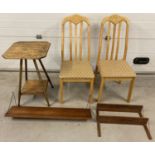 2 modern dining chairs together with a vintage occasional table and 2 wall hanging shelves.