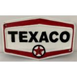A hexagonal shaped painted cast metal Texaco wall plaque, with fixing holes.