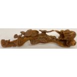 A highly carved wooden Chinese Ruyi sceptre with floral and bat detail.
