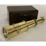 A small brass 2 drawer marine telescope in a wooden box.