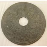 A very large circular medallion in the style of a Bi disc, with oriental style design to both sides.