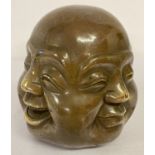 A brass paperweight of a 4 faced Buddha, impressed signature mark to underside.