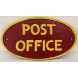 A painted cast iron oval shaped Post Office wall plaque.