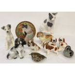 A collection of ceramic, resin and glass dog, cat and bird figurines.