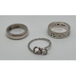 3 modern design silver rings. A plain band, a band with diamond and circle decoration and a