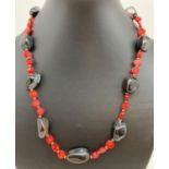 A 19" costume jewellery necklace made from disc shaped coral beads and polished onyx beads. With