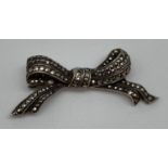 A vintage silver and marcasite set bow shaped brooch. Back of brooch marked "England Silver".