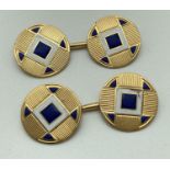 A pair of vintage gold cufflinks with engine turned decoration and white and blue enamel detail to