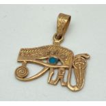 An 18ct gold Egyptian Eye Of Horus pendant with round turquoise stone, serpent detail and decorative