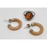 2 items of white metal and amber jewellery. A modern design ring set with an oval cabochon of cognac