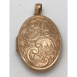 A 9ct gold oval locket with front floral engraved decoration. Approx. 3.5m long including bale.