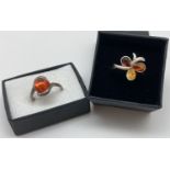 2 silver and amber set dress rings. A modern twist design mount set with a round cabochon of