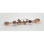 A vintage 9ct gold bar brooch with floral detail set with amethysts and small seed pearls (one