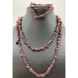 A 35" costume jewellery garnet chip necklace and matching elasticated bracelet.