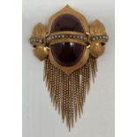 A Victorian 14ct gold mourning brooch set with a row of seed pearls and with tassle detail. A