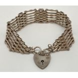 A vintage silver 6 bar gate bracelet with padlock shaped clasp and safety chain. Approx. 7.5