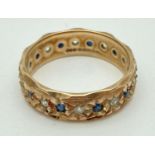 A vintage 9ct gold full eternity ring with diamond cut pattern and set with small round cut