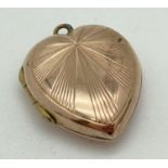 A vintage 9ct gold heart shaped locket with sunray design to front. Gold marks to back. Total weight