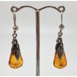 A pair of silver and amber drop style earrings with feather decoration. Hooks marked 925. Approx.