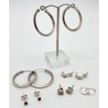 6 pairs of silver and white metal earrings in stud and hoop style. To include oval clear stone set