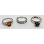 3 silver and white metal dress rings. A band style with Greek key detail set with opalite panels; an