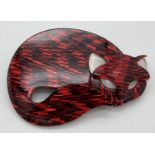 A Leah Stein style lucite brooch in the shape of a sleeping cat. Black and red pattern with white